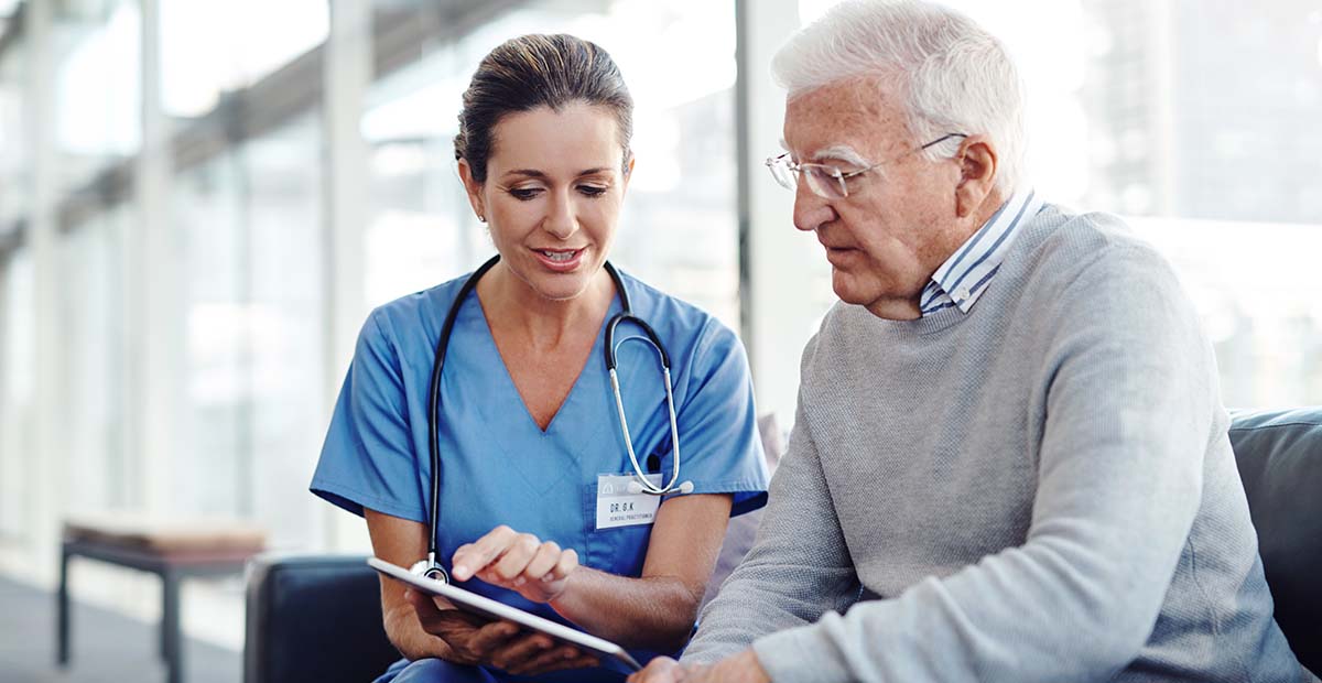 Doctor showing tablet to patient