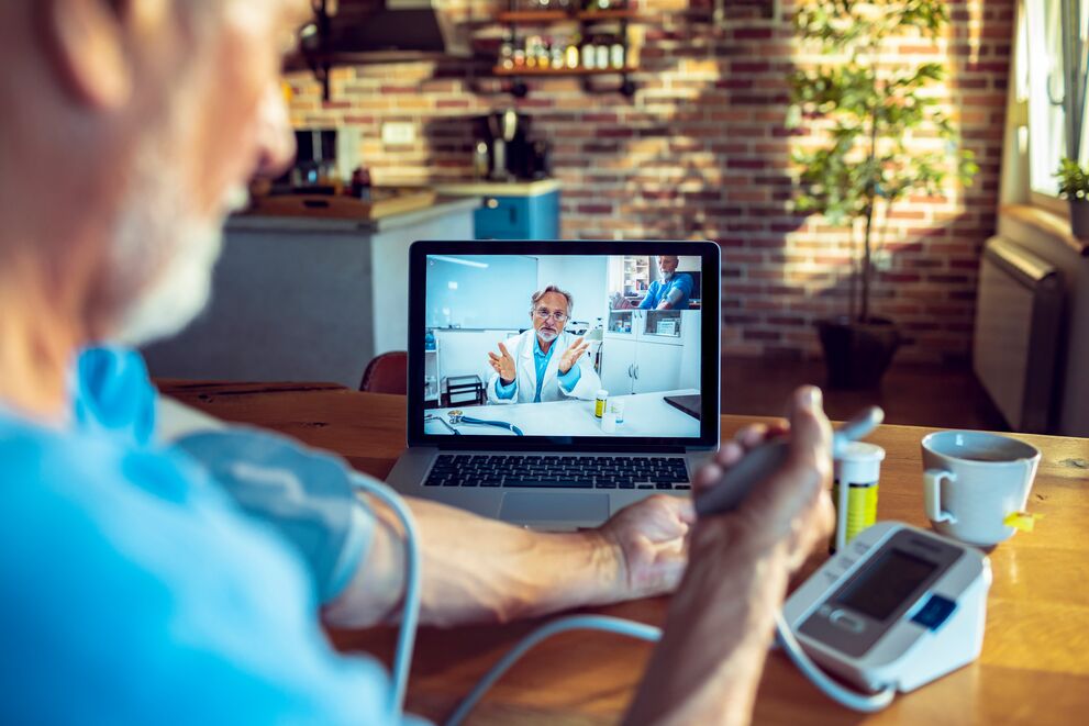 Person checking blood pressure during telehealth appointment