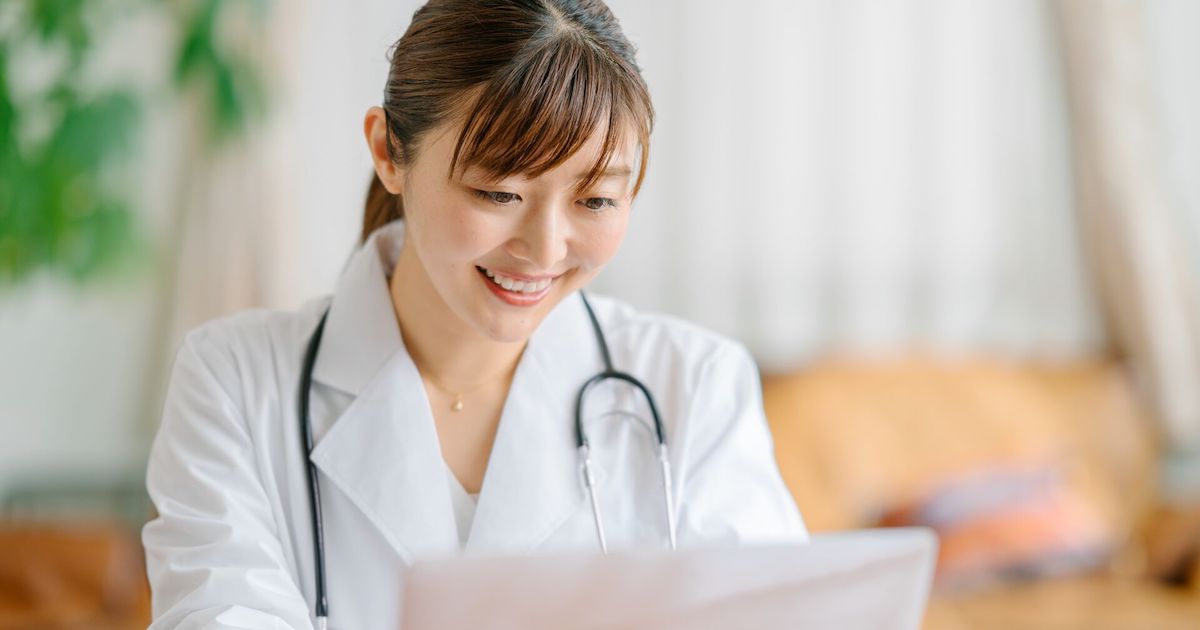 A doctor teleconsulting using a laptop computer