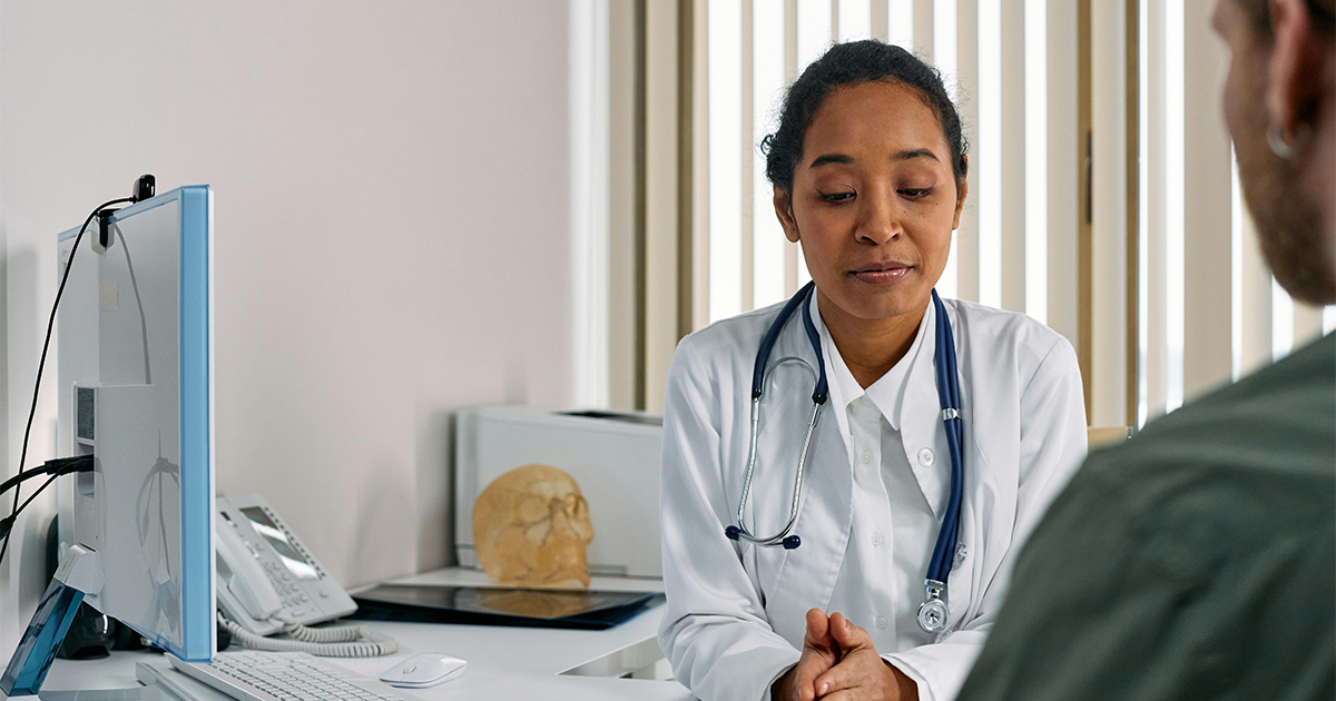 Patient signing off on treatment plan with doctor in office