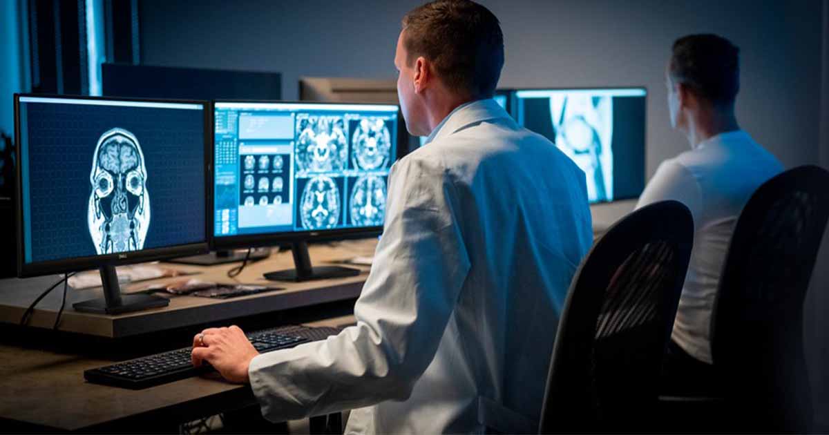 Healthcare workers looking at X-ray images on monitors