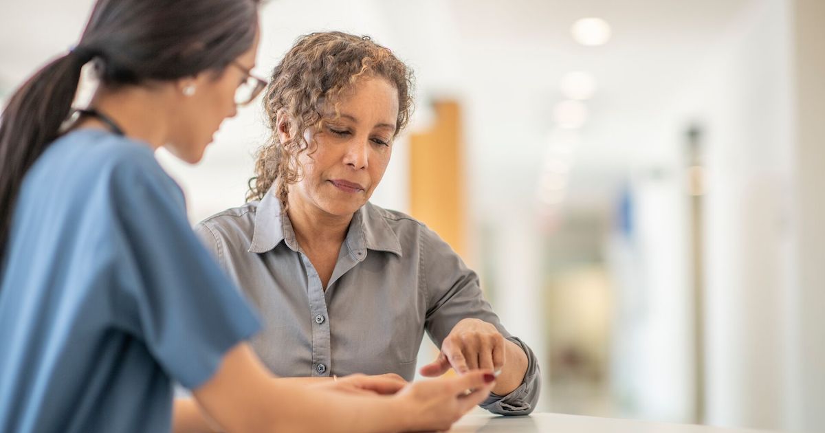Doctor showing patient phone