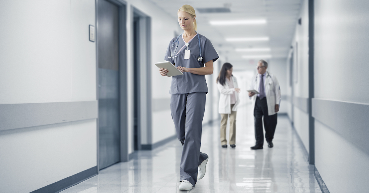 A doctor reading a patient's file on a digital tablet A doctor reading a patient's file on a digital tablet