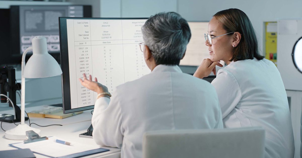 Healthcare workers looking at data on a monitor