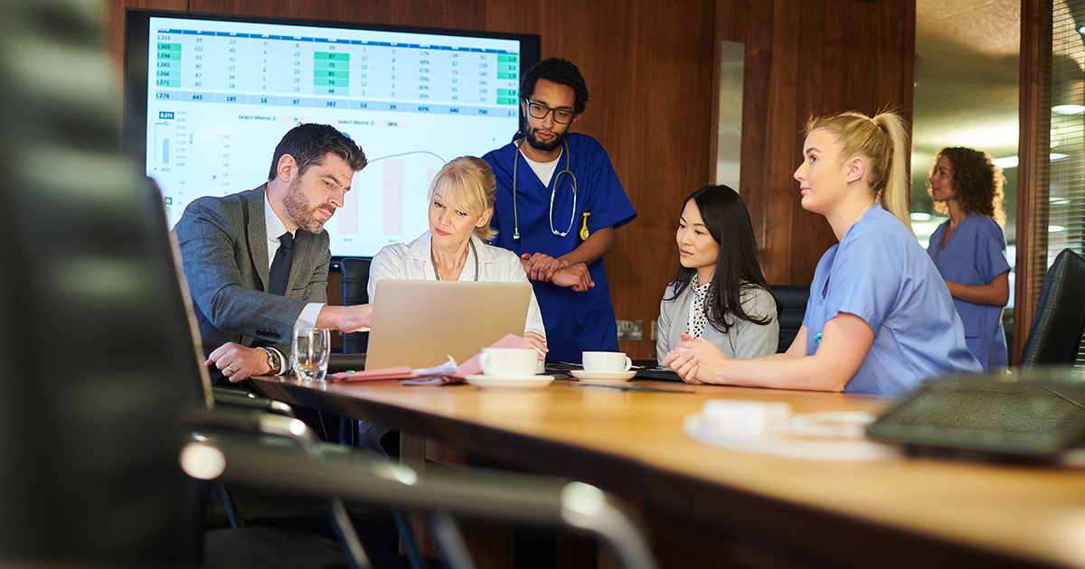 Healthcare workers meeting with business people