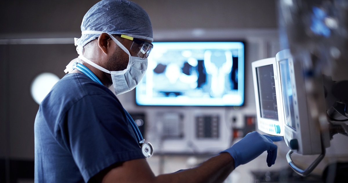 Surgeon standing in front of a monitor