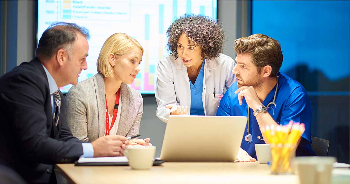 Healthcare workers meeting with administrators
