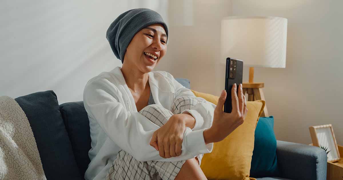 Smiling person looking at a smartphone