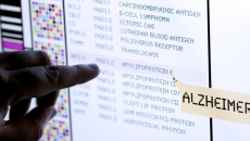 Finger points to a drug name on a list on a screen