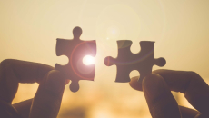 Hands holding puzzle pieces