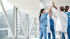 Group of healthcare workers sharing a high-five