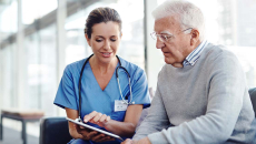Doctor showing tablet to patient