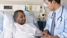 doctor using tablet with hospital patient