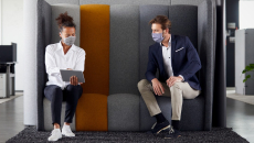 People examine tablet in office meeting