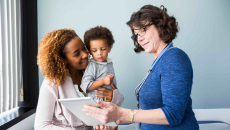 Parent and child meeting with doctor