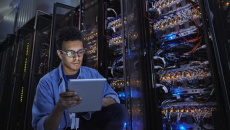 HIT computer engineer reviews security in a server room