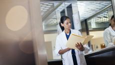 A clinician reading from a folder