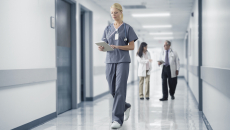 A nurse checking a medical record from a digital tablet