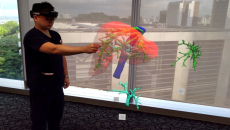 A doctor wearing an MR headset sees and controls a projected 3D hologram of a patient’s liver scan.