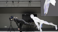Person in covering suit with electrodes poses, with a duplicate image of the figure nearby