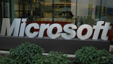 Microsoft sign in front of wide office window