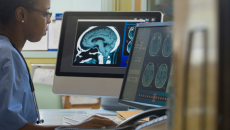 Radiologist looks at PACS monitor