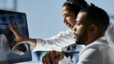 Healthcare workers looking at display screen