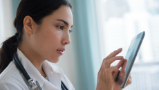 Medical professional using a tablet device