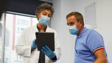 A medical professional using an EHR with a patient