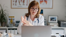 A medical professional on a laptop