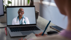 A doctor consults with a patient via video