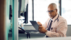 Doctor using EHR tablet