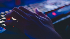 hand on a keyboard in the dark
