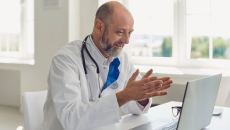 A doctor conducting teleconsultation using a laptop computer