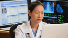 A doctor working on a laptop