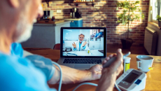 Person checking blood pressure during telehealth appointment
