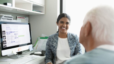 A doctor consulting a senior patient at a clinic office