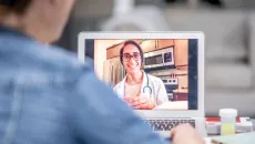 telehealth prescriber on laptop meets with a patient