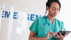 An emergency department doctor using a tablet