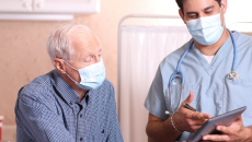 A doctor discussing to an elderly patient their test results using a tablet