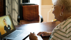 An elderly person in a online consultation with a doctor over laptop