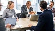 Businesspeople shaking hands at a meeting