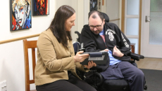 A Peninsula Health staff assisting a patient in inputting their care needs and preferences