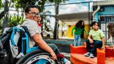 Student in a wheelchair on a playground