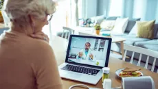 Senior patient speaks to her doctor on a telehealth call from home 