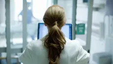 Healthcare worker looking at monitor
