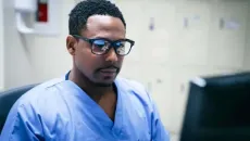 Clinician looks at patient data on screen