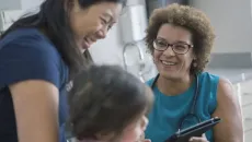Healthcare workers with patient looking at tablet