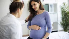 Doctor talking to pregnant person