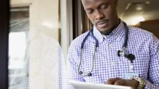 Doctor reviews data on a tablet
